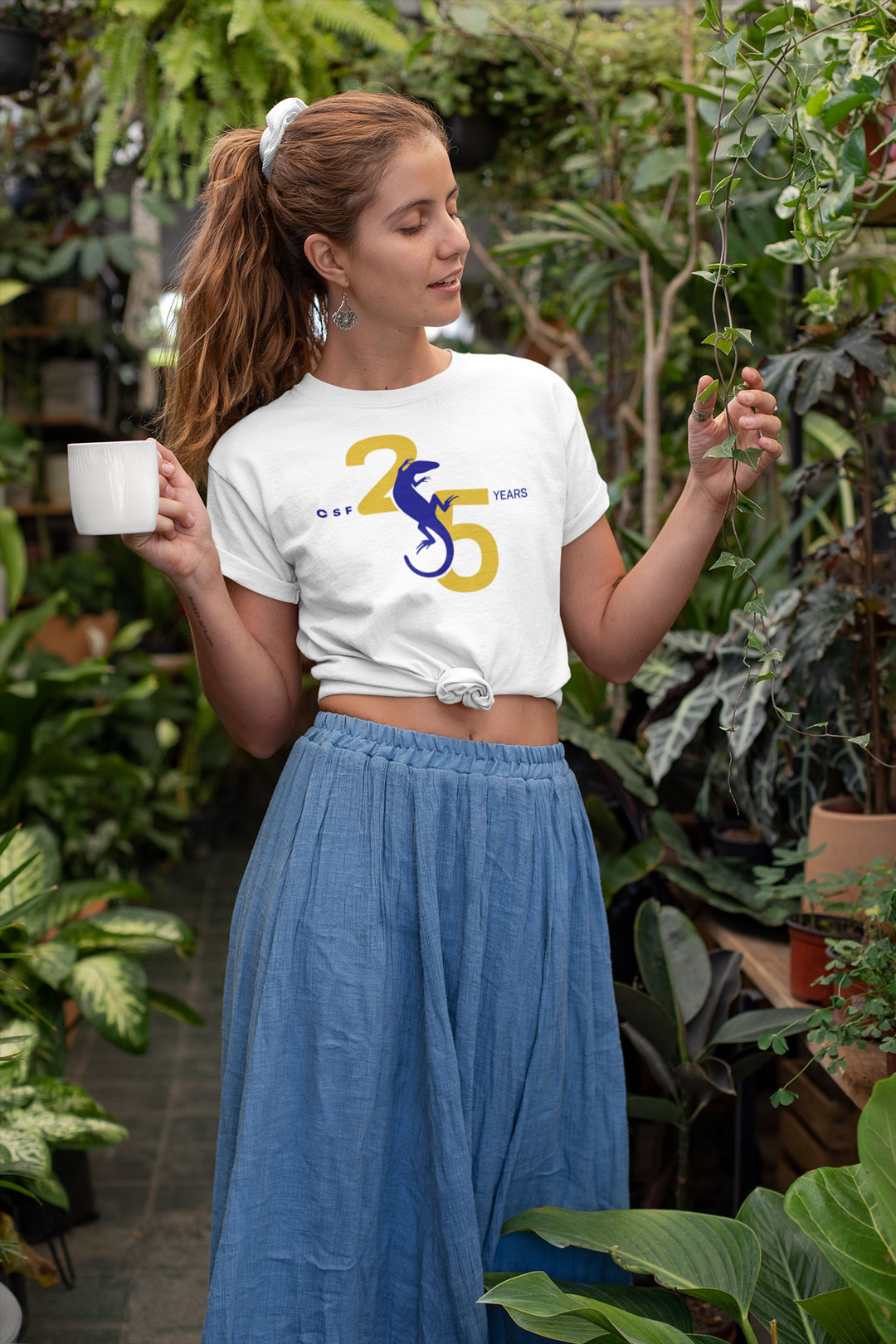 mockup-of-a-hippie-woman-with-a-knotted-t-shirt-at-a-greenhouse-27085